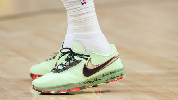 View of green and black Nike LeBron shoes.